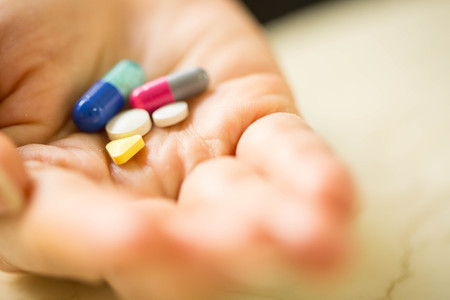 Drug pills on your hand for treat body.の写真素材