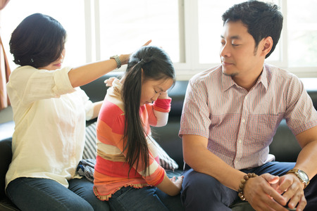 Asian family activity ,Mam setting hair to her daughter in live room.の写真素材