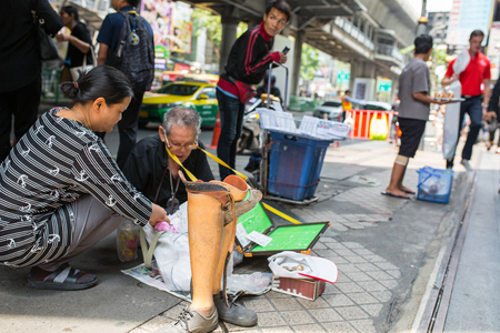 BANGKOK ,THAILAND - April 5 2016:Thai  Disabled people sell lottery beside street in Sukumvit Road Thailand.のeditorial素材