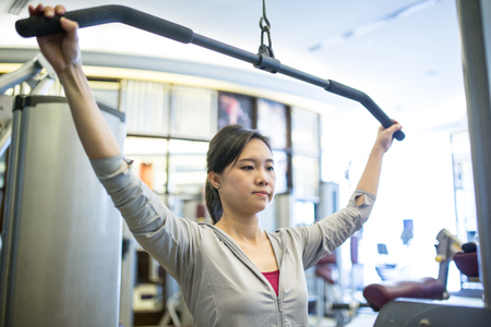 Asian woman exercise in fitness room.
