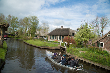 GIETHOORN, NETHERLANDS - April 22,2017: Tourist boat travel and visit Giethoorn village where call Venice of the North in Netherlands.のeditorial素材