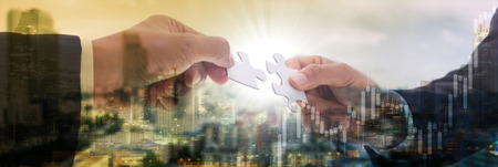 Cooperation puzzle partnership teamwork for support together with connect jigsaw puzzle together.の写真素材