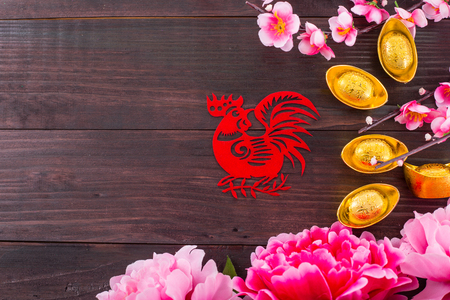Year of  chicken red paper on the wood table.の写真素材