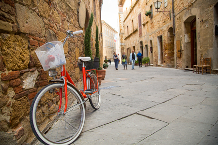 Bicycle stop beside building in Tuscany villageの写真素材
