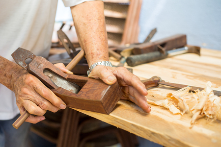 Wood carpenter working timb furniture in room workshop.の写真素材
