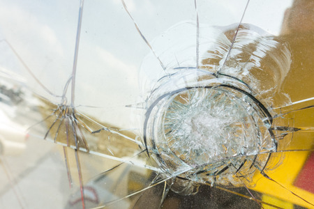 Broken glass after object impact in front of car.の写真素材