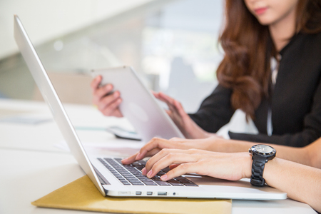 Two business woman working together in the office.の写真素材