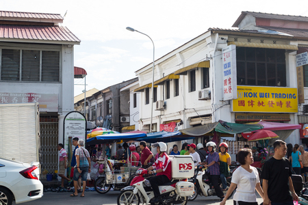 PENANG,MALAYSIA - SEPTEMBER 10 ,2016 : Post man ride motorcycle to send mail to people in Peang Malaysia.のeditorial素材