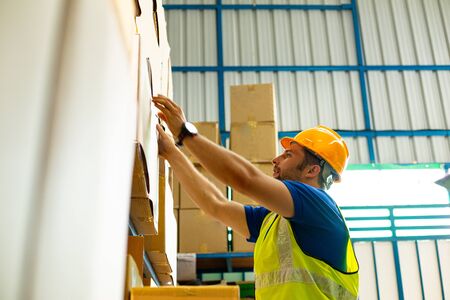 Delivery worker holding carton for ship to Customerの写真素材