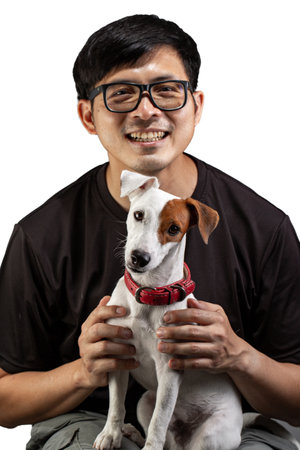 Asian owner and dog take photo for keep memorial together in studio.Cute pet jack russell terrier with white background.の写真素材