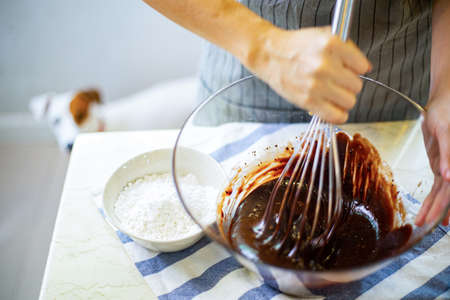 Homemake brownies whisking melted chocolate in a bowl.Dessert cooking  melt sweet ingradients food.の写真素材