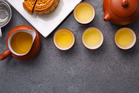 Chinese traditional festival mood cake with tea.Dessert mid - autumn background pattern.Tasty asian food.Teacup lifestyle beaverage bakery.の写真素材