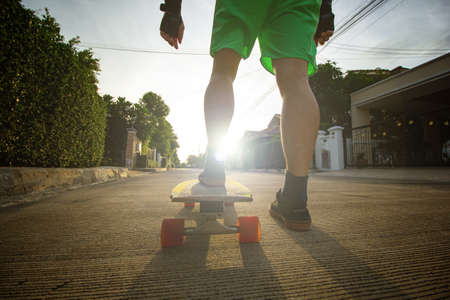 Surfskate player play skateboard exercise in the outdoor.Asian lifestyle for plays extream sports.Freestyle dynamic action skateboarding in the street.の写真素材