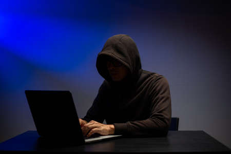 Cyber attack stealing information with program for hack password and personal data.Hacker typing keyboard with laptop for search and attack system.の写真素材
