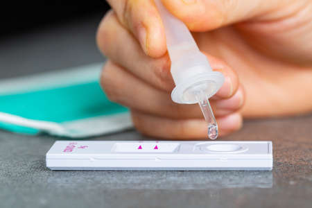 Drop nasal sample into rapid antigen test stick.PCR rantigen test for check coronavirus.Quick anlayze virus.Swab fast for check covid-19.の写真素材