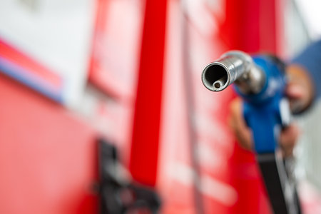 Holding nozzle petroleum for refill your fuel into engine care.Self service pump station with yourself. Service automobile gasoline.の写真素材