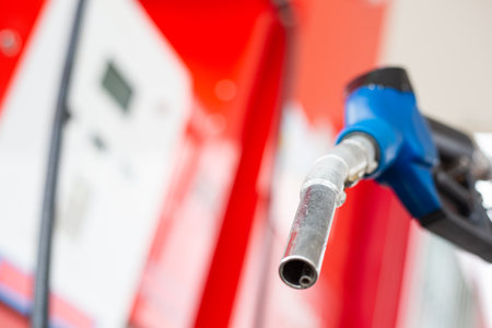 Holding nozzle petroleum for refill your fuel into engine care.Self service pump station with yourself. Service automobile gasoline.の写真素材