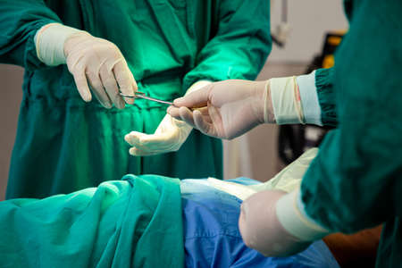 Operation surgical urgency.Medical team give scissors for open  wound of patient.Emergency room for...
