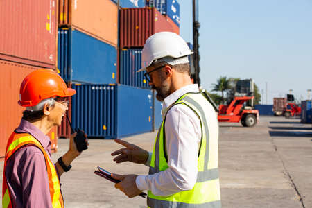 Business management discuss with foreman for communication before load container ship to customer.International cargo for distribution to warehouse.の写真素材