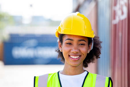 Container worker smile and happy with her job in transportation dock cargo to distribution to...