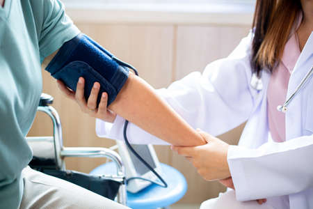 Medical adult for check and monitor cardiology pressure health in hospital.Cardiologist treatment disease pulse heart.Doctor holding hands for treatment patient.の写真素材