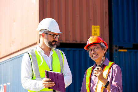 Business management discuss with foreman for communication before load container ship to...