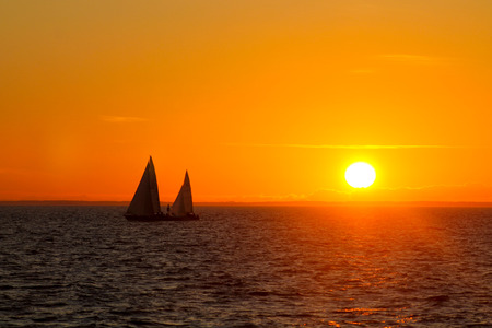 Two sailboats in a sunsetの写真素材