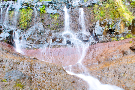 Flowing water and rock texture in the mountains of Madeiraの写真素材