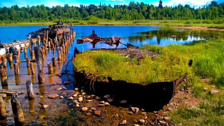 A grass-filled old shipwreck in Russian Kareliaの写真素材
