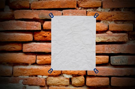 white used paper on on brick wall backgroundの写真素材