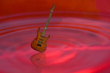 guitar and shadow on red waterの写真素材