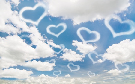 white heart on the blue sky and cloudyの写真素材
