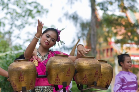 Hua Hin, THAILAND - November 5 : Unidentified young Thai woman is performing traditional Thai folk dance with traditional thai northeastern music instrument (Pongrang) ) during Buddha day festival on November 5, 2011 at Borfai Temple in Hua Hin Thailand.のeditorial素材