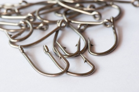 Stainless steel fishing hook on white の写真素材