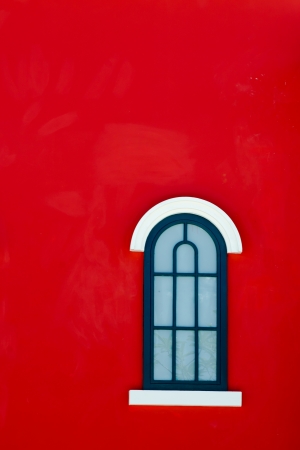 green vintage window on red wallの写真素材