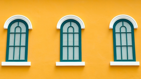 dark green vintage window on orange wallの写真素材