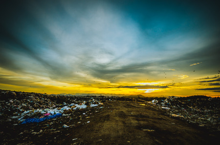 big garbage heap under sunsetの写真素材