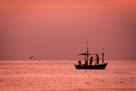 small fishing boat in the sea at Hua Hin Thailand in the morningの写真素材