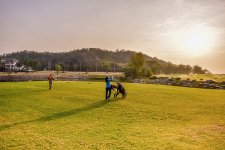 golf player and his caddy in the golf courseの写真素材