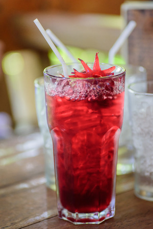 a glass of red roselle juiceの写真素材