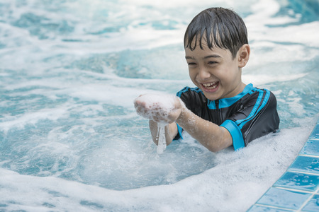 The Asian boy swimming on the weekend