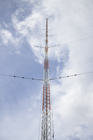 Communication antenna tower on blue skyの写真素材