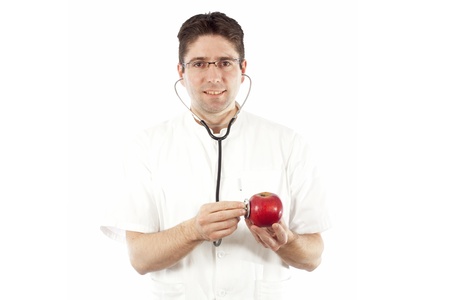 Doctor listening to an apple using stethoscopeの写真素材