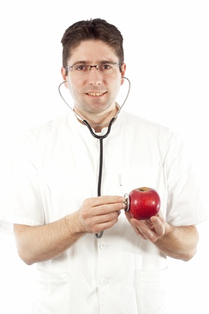 Doctor listening to an apple using stethoscopeの写真素材