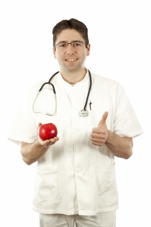 Doctor smiling and holding an appleの写真素材