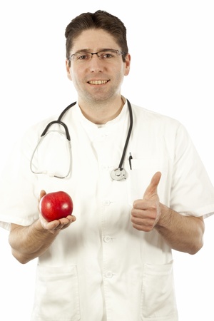 Doctor smiling and holding an appleの写真素材