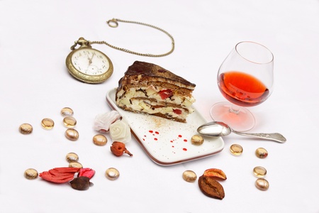 Delicious slice of fruit cake on plate and a clockの写真素材