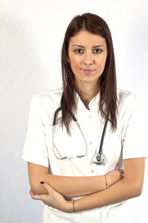 Pretty young female doctor posing in uniformの写真素材