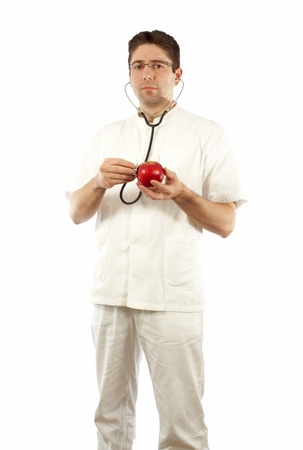 Doctor listening to an apple using stethoscopeの写真素材