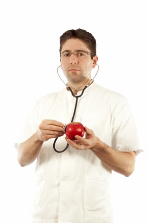 Doctor listening to an apple using stethoscopeの写真素材